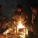 Armenian soldiers burning candles in farewell before Azerbaijan take over Karvachar region
