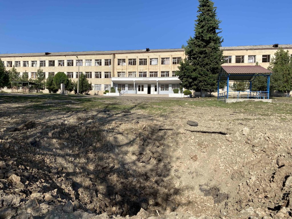 An impact crater from an attack by Azerbaijan which landed about 40 meters from the front of Stepanakert’s School Number 10. The blast overpressure broke windows and damage dozens of classrooms